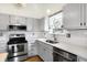 Bright kitchen with stainless steel appliances, white subway tile backsplash, and light gray cabinets at 12601 Slippery Rock Rd, Indianapolis, IN 46236