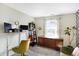Bright and airy living room with a standing desk, charming mid century modern dresser, and a comfortable seating area at 12601 Slippery Rock Rd, Indianapolis, IN 46236
