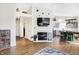 Bright and airy living room featuring wood floors, fireplace, and open layout to kitchen at 12601 Slippery Rock Rd, Indianapolis, IN 46236