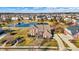 Expansive aerial view of the property showcasing the neighborhood, a pond, and manicured landscaping at 13788 Four Seasons Way, Carmel, IN 46074