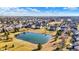 An aerial view reveals a neighborhood with a serene pond and lush green space at 13788 Four Seasons Way, Carmel, IN 46074