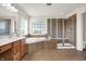 Well lit bathroom featuring tile floor, garden tub and stand up shower with glass doors at 13788 Four Seasons Way, Carmel, IN 46074