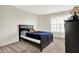 Comfortable bedroom with a well-lit dresser and window, featuring carpeted floors at 13788 Four Seasons Way, Carmel, IN 46074