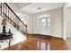Inviting foyer with hardwood floors, decorative glass door, and a staircase with wrought iron railing at 13788 Four Seasons Way, Carmel, IN 46074