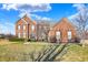 Stunning two-story red brick home with meticulously maintained landscaping and a lush green lawn at 13788 Four Seasons Way, Carmel, IN 46074