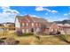 Aerial view of a beautiful red brick home highlighting the manicured lawn and surrounding landscape at 13788 Four Seasons Way, Carmel, IN 46074