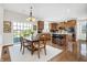 Spacious eat-in kitchen with island seating, hardwood floors, and a sliding glass door to the outside at 13788 Four Seasons Way, Carmel, IN 46074