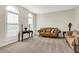 This living room has neutral walls, carpet floors, a brown couch and two windows for natural light at 13788 Four Seasons Way, Carmel, IN 46074