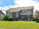 Expansive backyard with lush green grass and a brick-and-siding home exterior at 14034 Wicklow Ln, Fishers, IN 46040