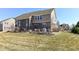 Backyard view with patio seating, partially brick exterior elevation, and lawn at 14034 Wicklow Ln, Fishers, IN 46040