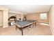 Basement recreation area with a ping pong table, workout equipment and an egress window at 14034 Wicklow Ln, Fishers, IN 46040