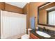 Bathroom with vanity sink, granite countertop, decorative mirror and shower with patterned curtain at 14034 Wicklow Ln, Fishers, IN 46040