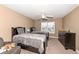 Cozy bedroom with neutral decor, two beds, ceiling fan, and natural light at 14034 Wicklow Ln, Fishers, IN 46040