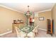Bright dining room with a glass-top table, seating for six, and stylish light fixture at 14034 Wicklow Ln, Fishers, IN 46040