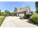 Long driveway leading to a three car garage, with a basketball hoop at 14034 Wicklow Ln, Fishers, IN 46040