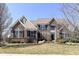 Beautiful brick home with manicured lawn, large windows, black shutters, and well-kept landscaping at 14034 Wicklow Ln, Fishers, IN 46040