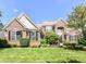 Charming brick home featuring manicured landscaping and a well-maintained lawn at 14034 Wicklow Ln, Fishers, IN 46040
