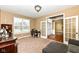 Inviting living area with lots of light, a desk and chair, and a view into the dining area at 14034 Wicklow Ln, Fishers, IN 46040