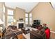 Bright living room with vaulted ceilings, fireplace, and comfortable brown sofas at 14034 Wicklow Ln, Fishers, IN 46040