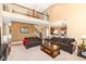Spacious living room with high ceilings, staircase, and comfortable brown seating at 14034 Wicklow Ln, Fishers, IN 46040
