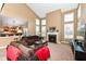 Comfortable living room featuring a fireplace, ample natural light, and brown sofas at 14034 Wicklow Ln, Fishers, IN 46040