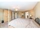 Large primary bedroom with four poster bed, ceiling fan, and access to ensuite bathroom at 14034 Wicklow Ln, Fishers, IN 46040