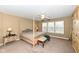 Spacious primary bedroom featuring a four-poster bed, bench, and ample natural light from large windows at 14034 Wicklow Ln, Fishers, IN 46040