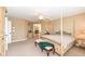 A well-lit primary bedroom includes a four poster bed, a window and matching night stands at 14034 Wicklow Ln, Fishers, IN 46040