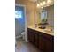Bathroom featuring double sinks, spacious counter, framed mirror, lighting, and window views at 14309 Shooting Star Dr, Noblesville, IN 46060