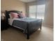 Bedroom featuring a bed, window, side table, lamp, and neutral tones to create a relaxing space at 14309 Shooting Star Dr, Noblesville, IN 46060
