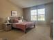 Cozy bedroom with carpet, neutral walls, and a large window offering plenty of natural light at 14309 Shooting Star Dr, Noblesville, IN 46060