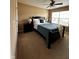 Comfortable bedroom features neutral walls, large window, ceiling fan and black wood furniture at 14309 Shooting Star Dr, Noblesville, IN 46060