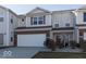 Well-maintained townhouse featuring a two-car garage and welcoming front entrance at 14309 Shooting Star Dr, Noblesville, IN 46060