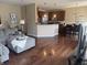 Open-concept living area showcasing hardwood floors, seamless transition to kitchen and dining spaces at 14309 Shooting Star Dr, Noblesville, IN 46060