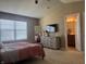 Spacious main bedroom with neutral tones, large window, walk-in closet, and an ensuite bathroom at 14309 Shooting Star Dr, Noblesville, IN 46060