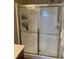 Shower enclosure featuring glass doors, shower head, and ample storage for bath products at 14309 Shooting Star Dr, Noblesville, IN 46060