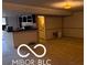 Basement living area features bar, cabinets, neutral carpeting, and plenty of open space at 15237 Citation Rd, Carmel, IN 46032