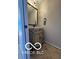 Charming powder room features a carved vanity, granite counter, and decorative mirror at 15237 Citation Rd, Carmel, IN 46032