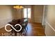 Elegant dining room features a classic chandelier and natural light, perfect for entertaining guests at 15237 Citation Rd, Carmel, IN 46032