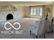 Cozy living room boasts a fireplace, neutral carpet, and natural light at 15237 Citation Rd, Carmel, IN 46032