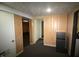 View of the basement showing access to multiple rooms and a compact refrigerator at 1739 Forest Dr, Indianapolis, IN 46227