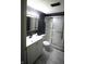 Updated bathroom with a modern vanity, black accent wall, and a shower with glass doors at 1739 Forest Dr, Indianapolis, IN 46227