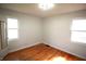 The bedroom features warm hardwood floors and two windows at 1739 Forest Dr, Indianapolis, IN 46227