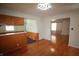 Bright dining area with hardwood floors, wood paneling, and access to other rooms at 1739 Forest Dr, Indianapolis, IN 46227