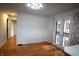 Sunlit dining room boasts hardwood floors, a stylish light fixture, and classic french doors with decorative curtains at 1739 Forest Dr, Indianapolis, IN 46227