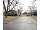 A charming house with a long driveway leading to a detached garage, surrounded by trees at 1739 Forest Dr, Indianapolis, IN 46227