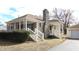 Charming single-Gathering home featuring a stone chimney, inviting front porch, and detached garage at 1739 Forest Dr, Indianapolis, IN 46227