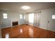 Bright living room with hardwood floors, fireplace, built-in bookshelves, and large windows at 1739 Forest Dr, Indianapolis, IN 46227