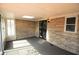 Sunroom featuring stone accent wall, carpet flooring, skylight, and lots of natural light at 1739 Forest Dr, Indianapolis, IN 46227