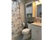 Nautical-themed bathroom with white vanity, toilet, and tub/shower combination at 1913 Albany St, Beech Grove, IN 46107